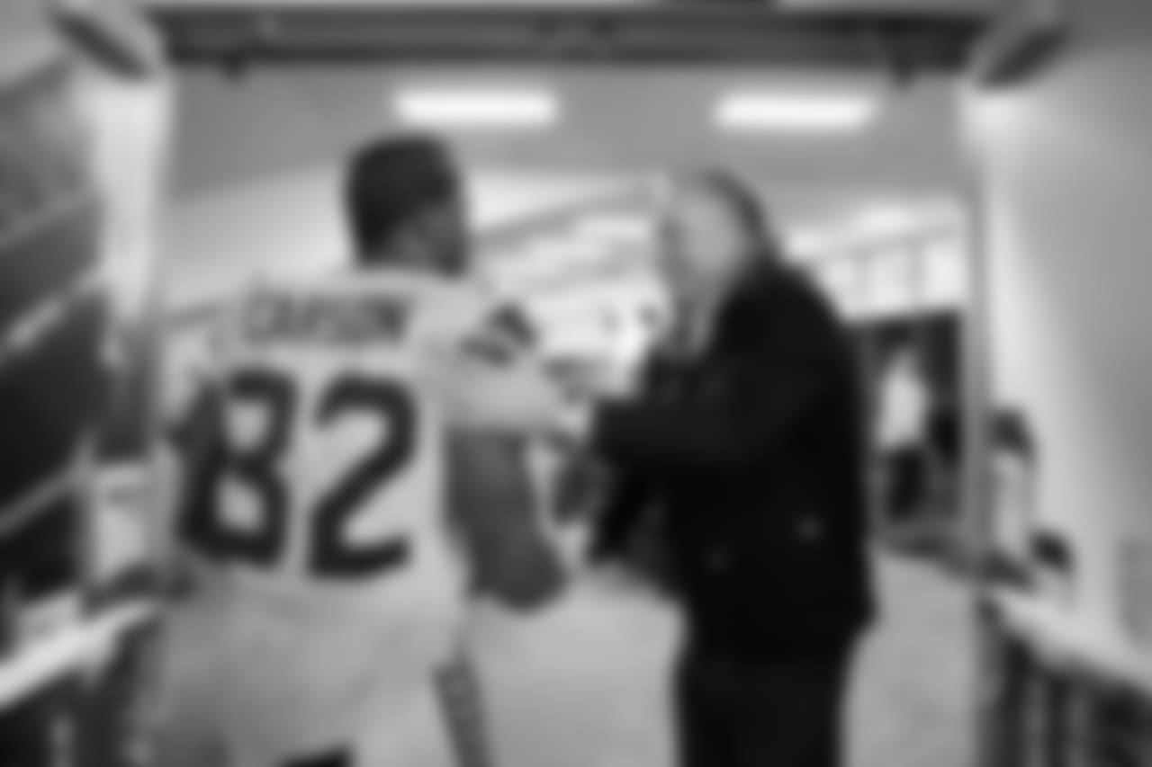 Seahawks vice-chairman Bert Kolde greets Chris Carson at the entrance of the locker room after the win.