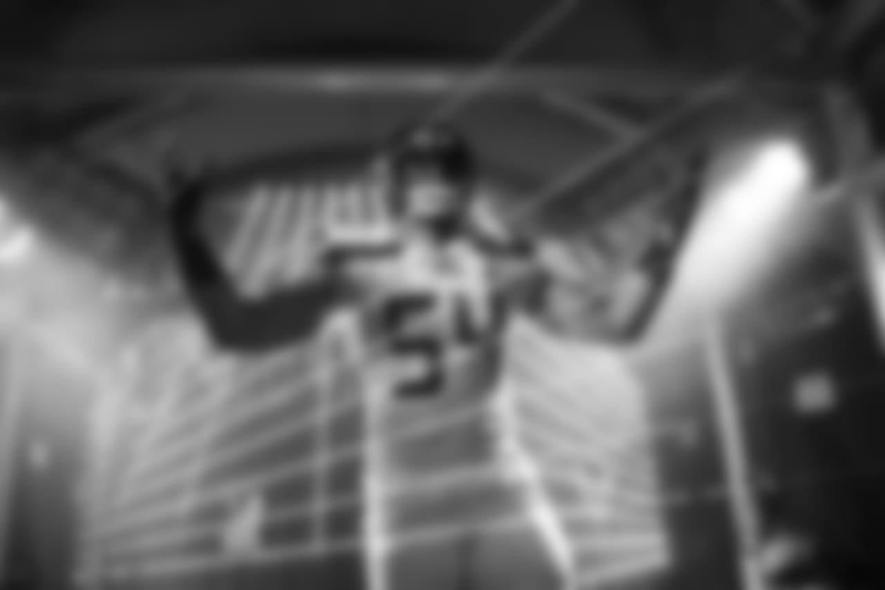 Linebacker Bobby Wagner makes his way through the fog and lasers of the tunnel as his name is announced during pregame introductions.