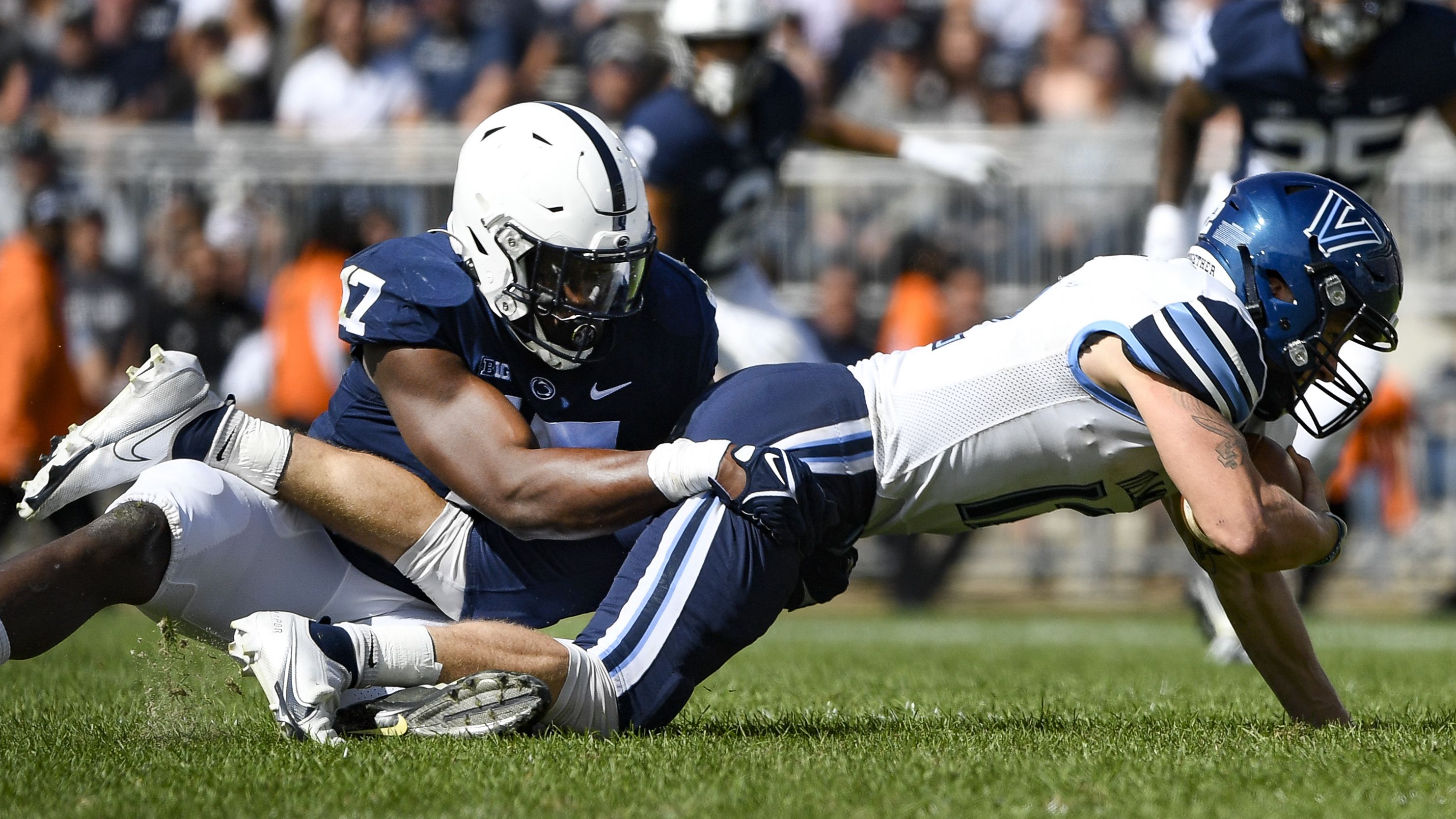 Penn State defensive end Arnold Ebiketie (17) sacks Villanova quarterback Daniel Smith, right, during an NCAA college football game in State College, Pa., on Saturday, Sept. 25, 2021. (AP Photo/Barry Reeger)