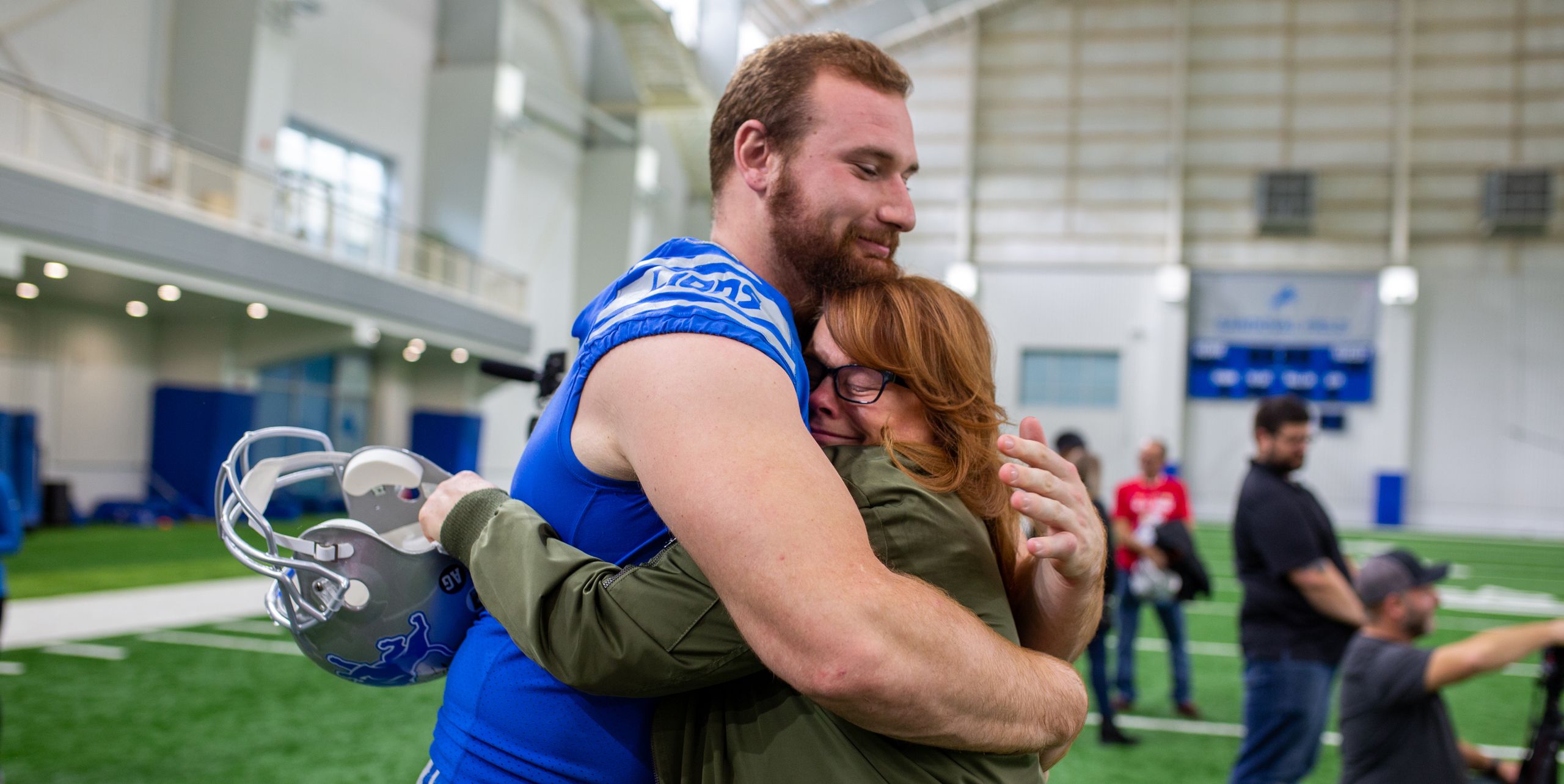 Detroit Lions offensive lineman Frank Ragnow (77) with a family member of a fallen servicemember from the Tragedy Assistance Program for Survivors after the team’s walkthrough practice.