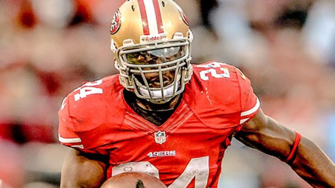 San Francisco 49ers rookie RB Anthony Dixon (33) high steps over a