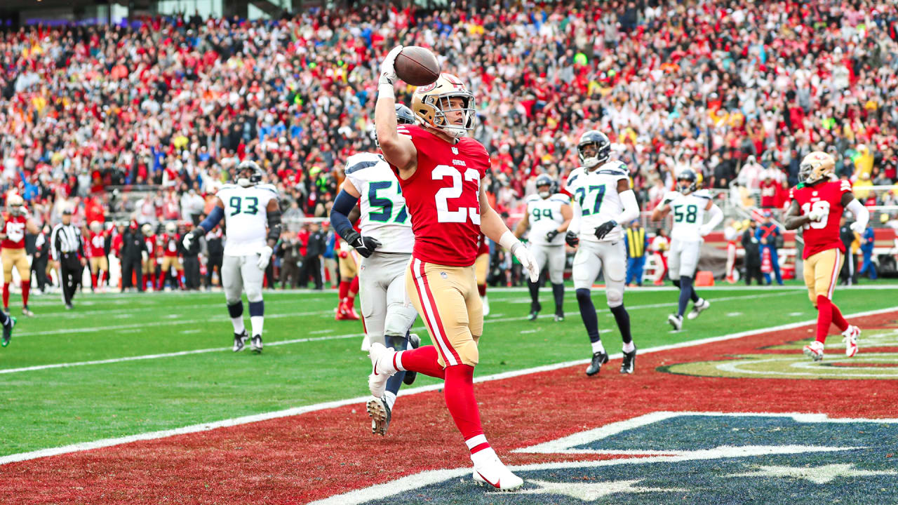 San Francisco 49ers running back Christian McCaffrey stiff-arms a Los  Angeles Rams defender to turf on a 14-yard touchdown run