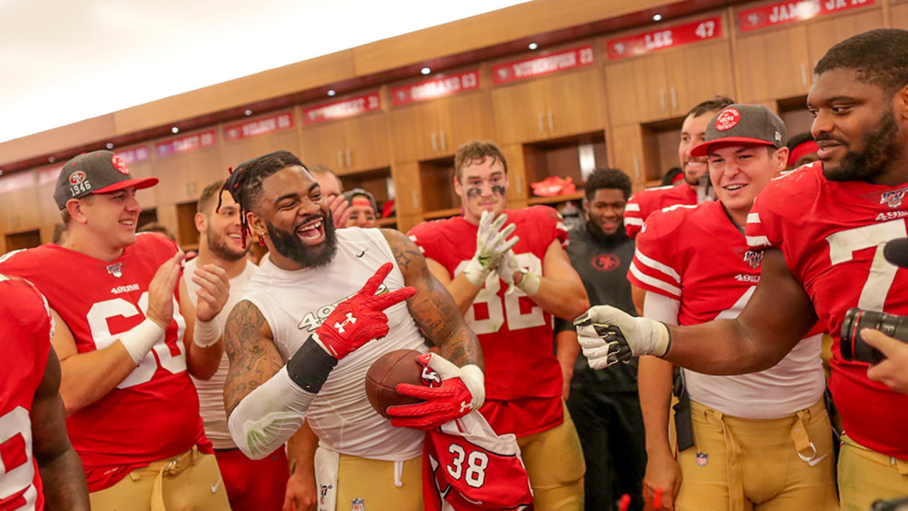 The San Francisco 49ers offensive line celebrates in the locker