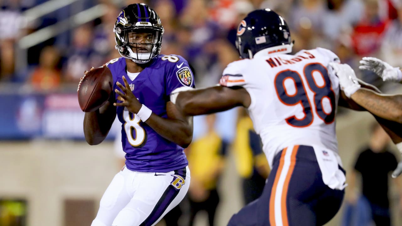 Baltimore Ravens quarterback Lamar Jackson, center leaps up after