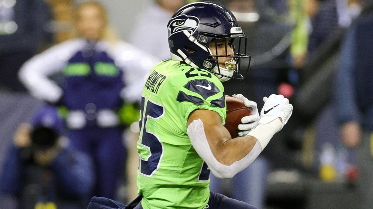 Travis Homer of the Seattle Seahawks looks on before their game