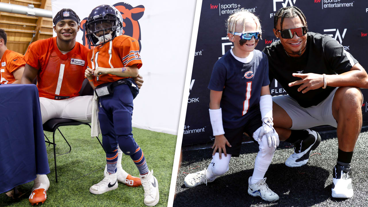 A Chicago Bears fan holds a quarterback Justin Fields jersey