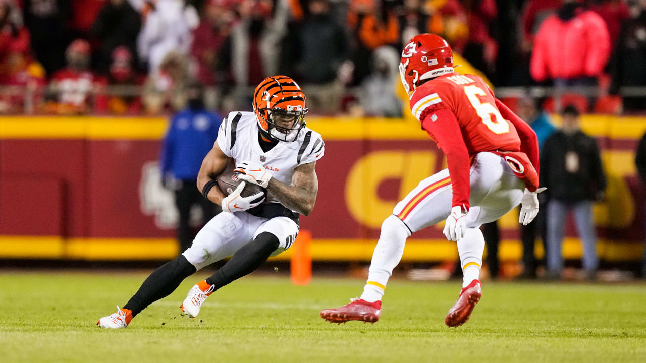 Cincinnati Bengals running back Joe Mixon holds the Lamar Hunt trophy as  Ja'Marr Chase, left and Tee HIggins, center, watch after they beat the  Kansas City Chiefs in the NFL AFC Championship