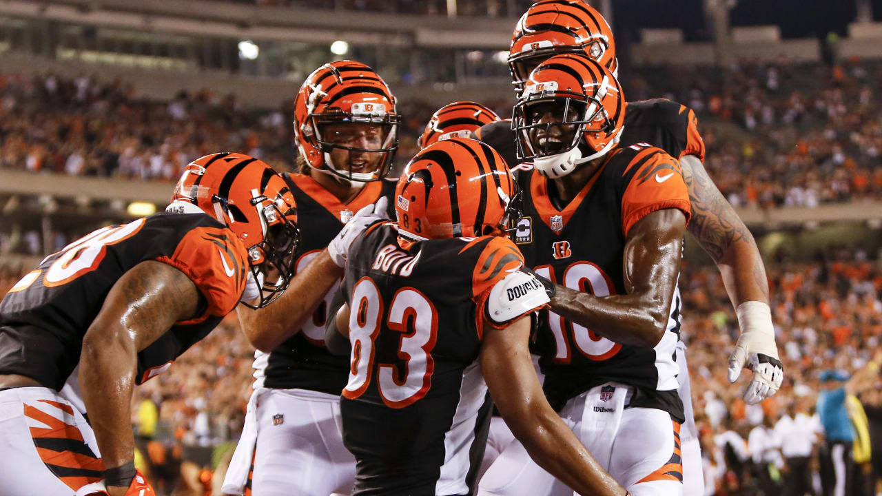 Cincinnati Bengals quarterback Andy Dalton, left, and wide receiver A.J.  Green (18) run back to the sidelines after Green's touchdown during the  first half of an NFL football game against the Miam …