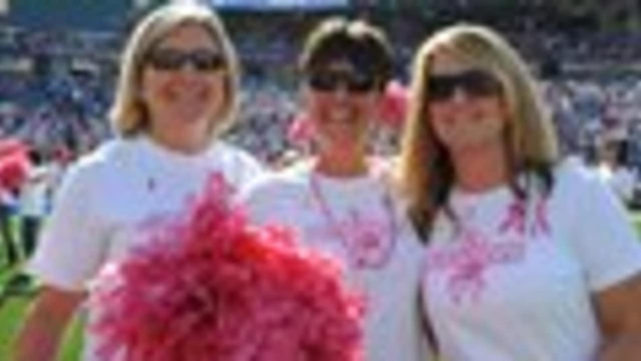 A fan wears a Dallas Cowboy cheerleader costume and pink gloves in