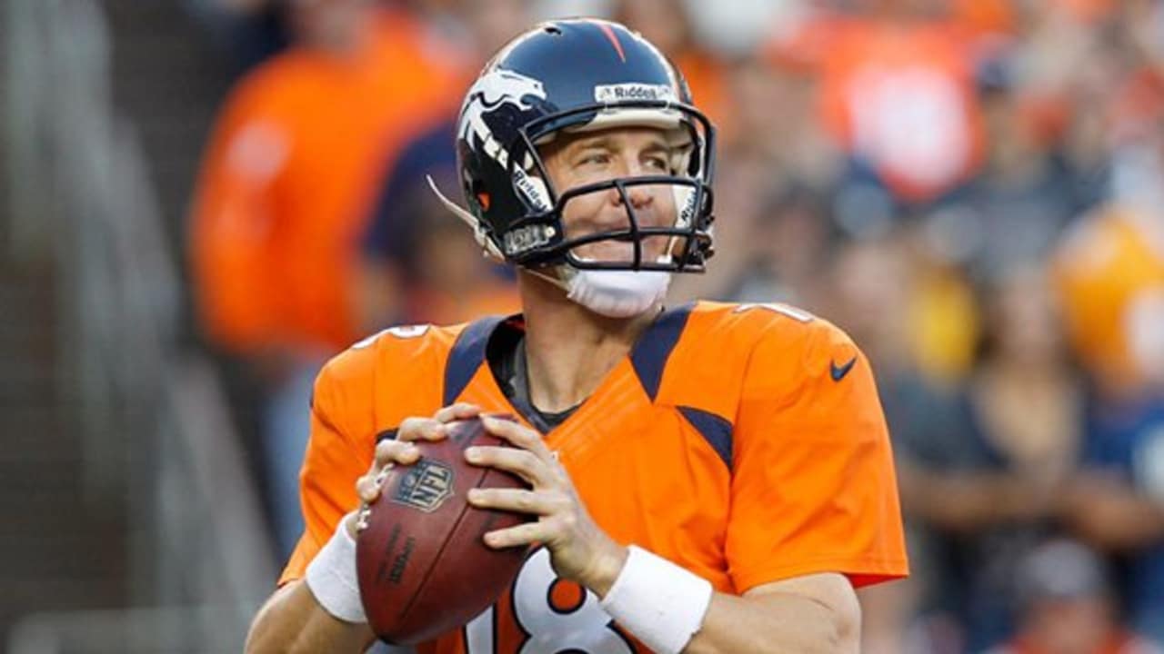 Denver Broncos quarterback Peyton Manning (18) sits on the bench