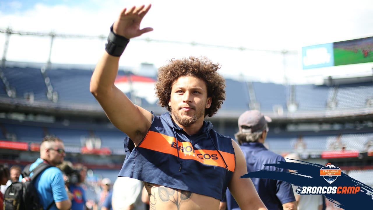 Denver Broncos running back Phillip Lindsay leaves the field after an NFL  football game against the New England Patriots while wearing a headband  with colors supporting Crucial Catch initiative, Sunday, Oct. 18