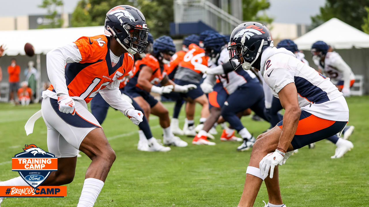 DENVER, CO - OCTOBER 31: Denver Broncos cornerback Pat Surtain II (2) and  free safety Justin Simmons (31) look on as an injured player is tended to  during a game between the