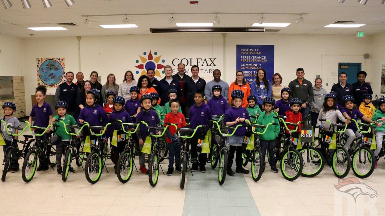 Broncos distribute bikes to students at Colfax Elementary School