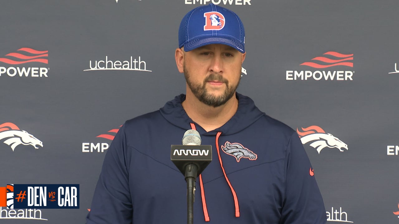 Denver Broncos offensive coordinator Justin Outten, left, and