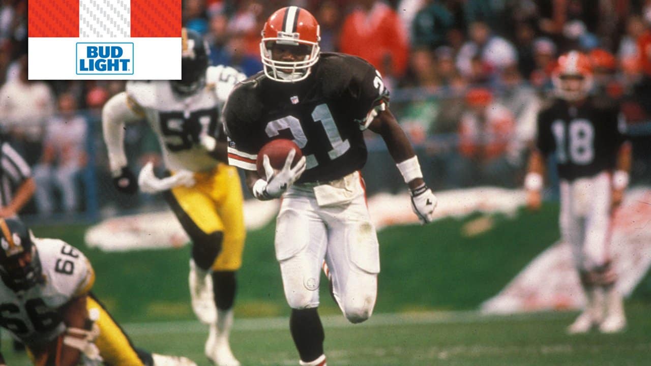 Former Cleveland Browns Eric Metcalf waves to fans during the