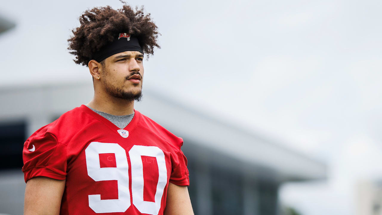 TAMPA, FL - MAY 13: Tampa Bay Buccaneers Logan Hall (90) talks with a team  official before the Tampa Bay Buccaneers Rookie Minicamp on May 13, 2022 at  the AdventHealth Training Center