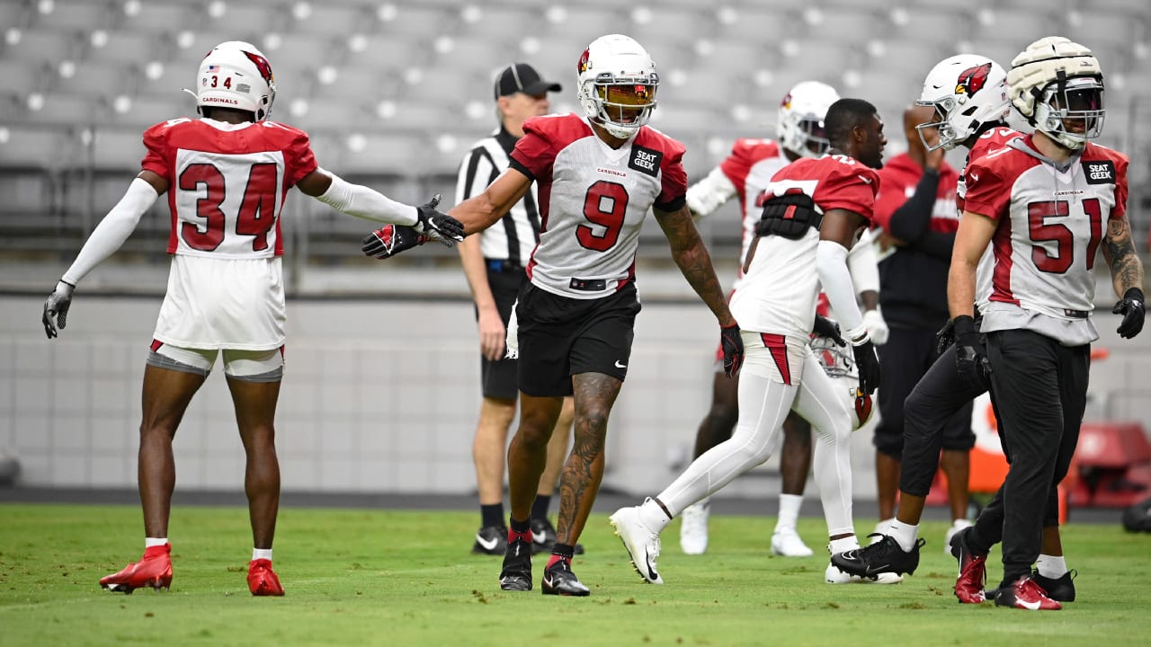 Arizona Cardinals wide receiver Rondale Moore, right, runs with the ball as  Cardinals safety Jalen Thompson, left, closes in during NFL football  training camp practice at State Farm Stadium Saturday, July 29