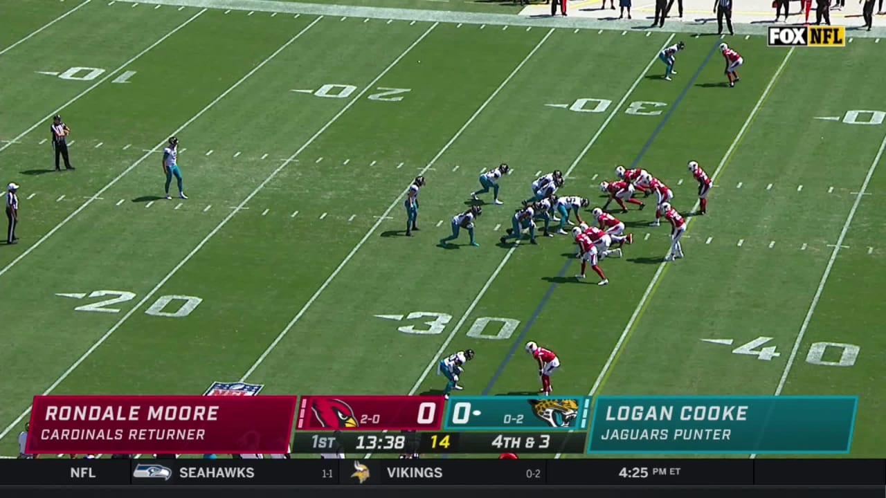 The Cardinals Flag Runners sprint on to the field prior to an NFL