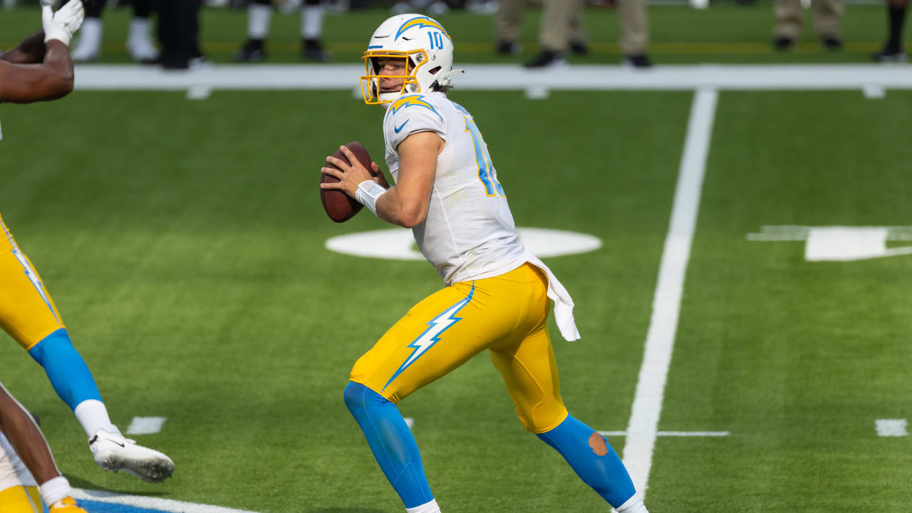 Los Angeles Chargers quarterback Justin Herbert (10) adjusts his helmet as  he warms up before an NFL football game against the Seattle Seahawks  Sunday, Oct. 23, 2022, in Inglewood, Calif. (AP Photo/Marcio