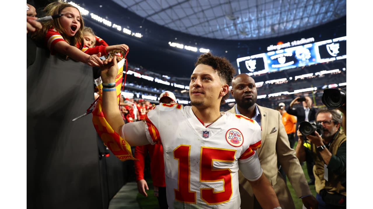 Kansas City Chiefs tight end Travis Kelce (87) and Kansas City Chiefs  linebacker Leo Chenal (54) greet each other during warmups before an NFL  divisional round playoff football game against the Jacksonville