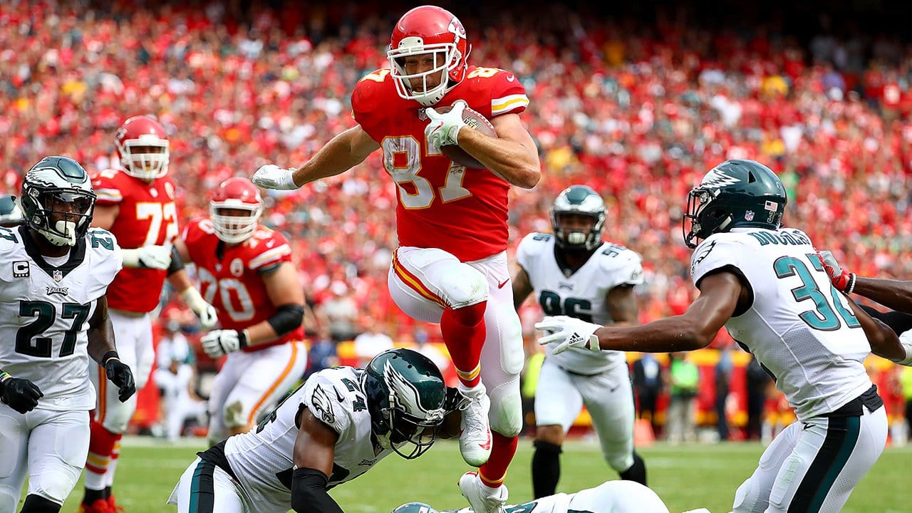 Travis Kelce leaps into the air with the ball