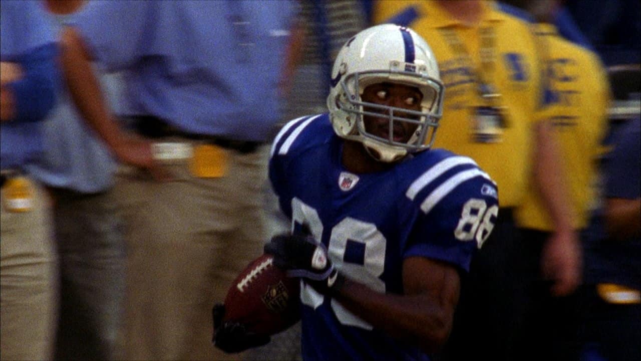 Indianapolis Colts wide receiver Marvin Harrison (L) hauls in a 12