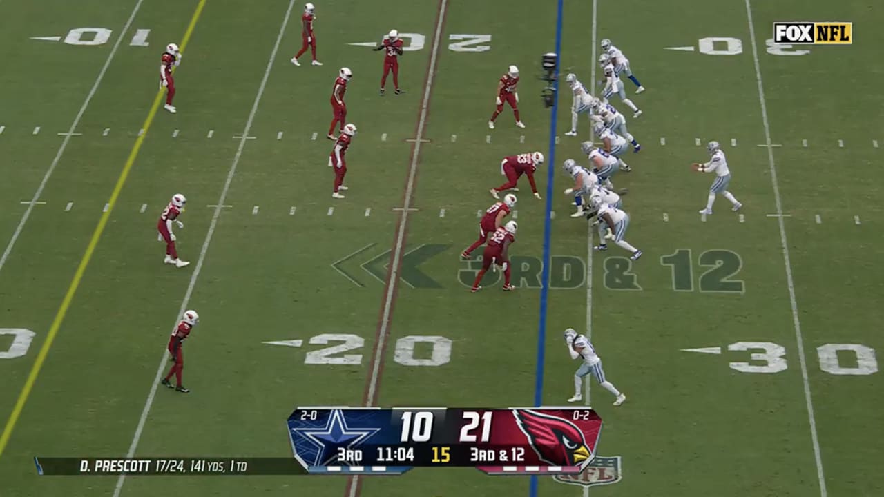 Dallas Cowboys quarterback Dak Prescott jukes Arizona Cardinal out