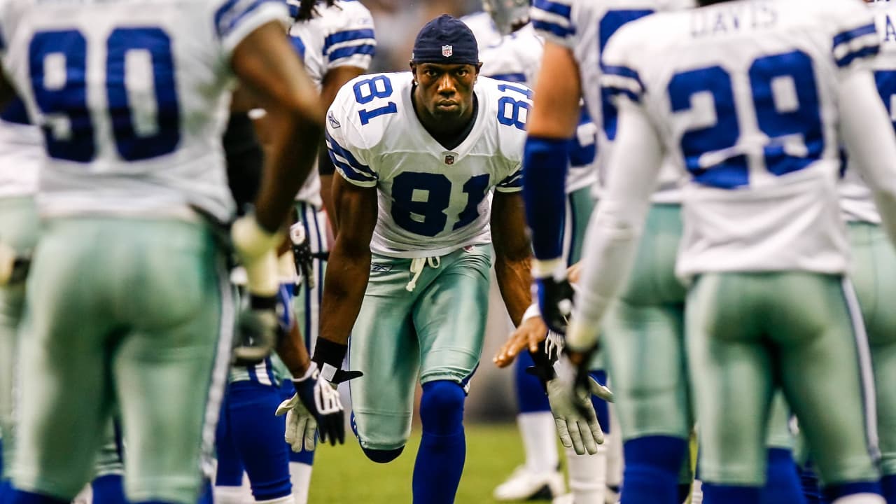 Dallas Cowboys wide receiver Terrell Owens (81) pulls in a 48-yard pass as  Green Bay Packers linebacker A.J. Hawk (50) defends in the second quarter  in their NFL football game in Irving