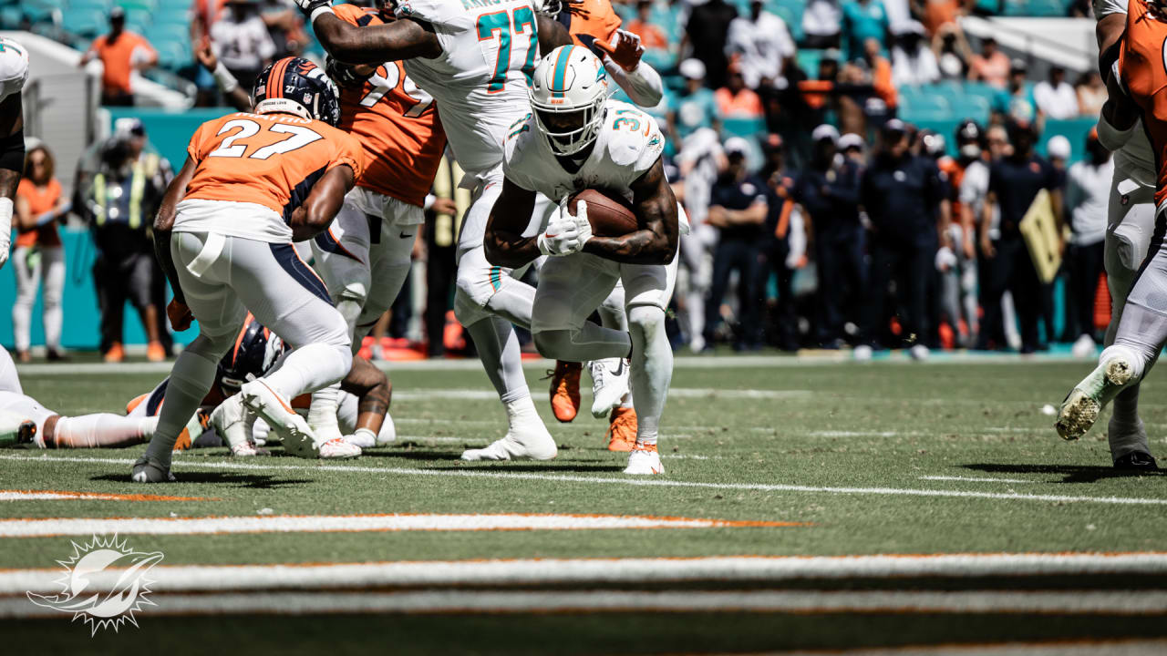 Miami Dolphins running back Raheem Mostert (31) celebrates with teammates  after scoring a touchdown against the Denver Broncos during the second  quarter of an NFL football game at Hard Rock Stadium, Sunday