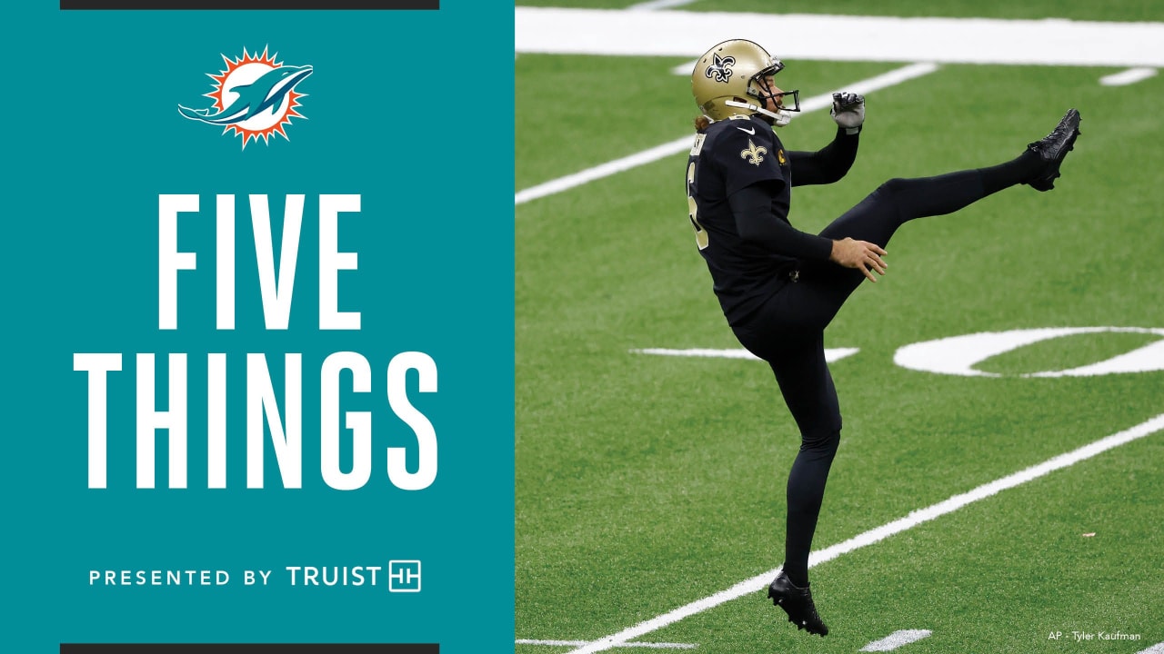 Miami Dolphins punter Thomas Morstead (4) holds the football during the  second half of an NFL