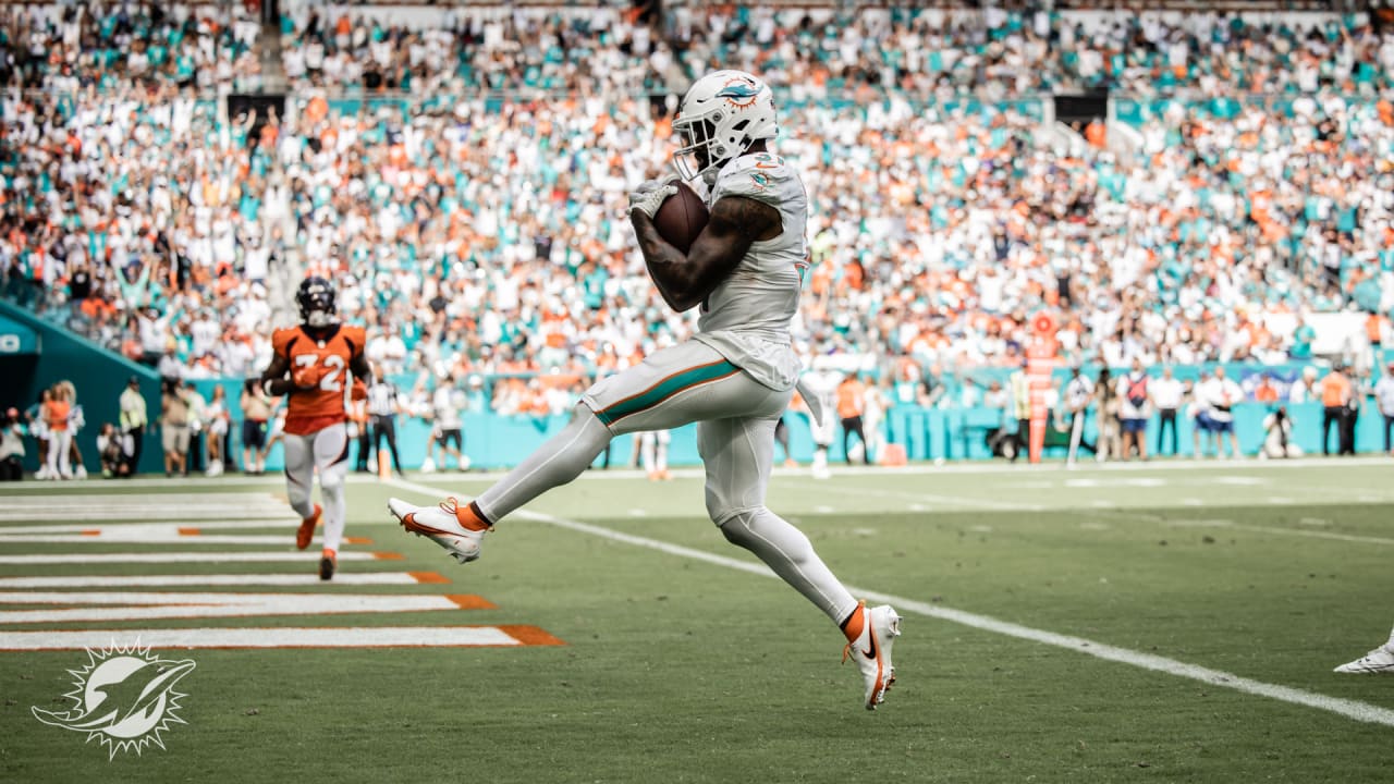 Tua Tagovailoa of the Miami Dolphins hands the ball off to Raheem