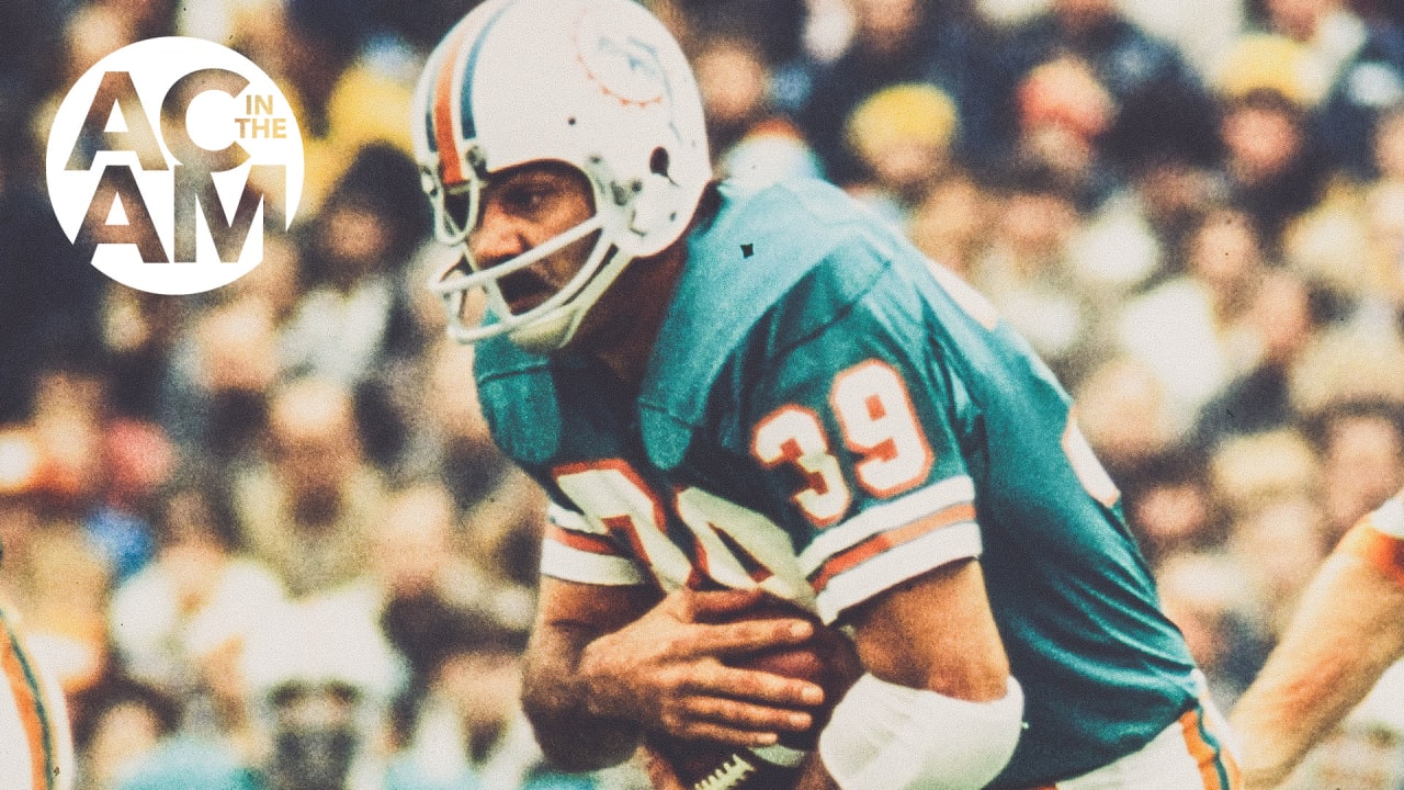 Mary Anne Shula hugs Tom Garfinkle, President and CEO of the Miami  Dolphins, during a ceremony honoring former head coach Don Shula during  half time of an NFL football game against the