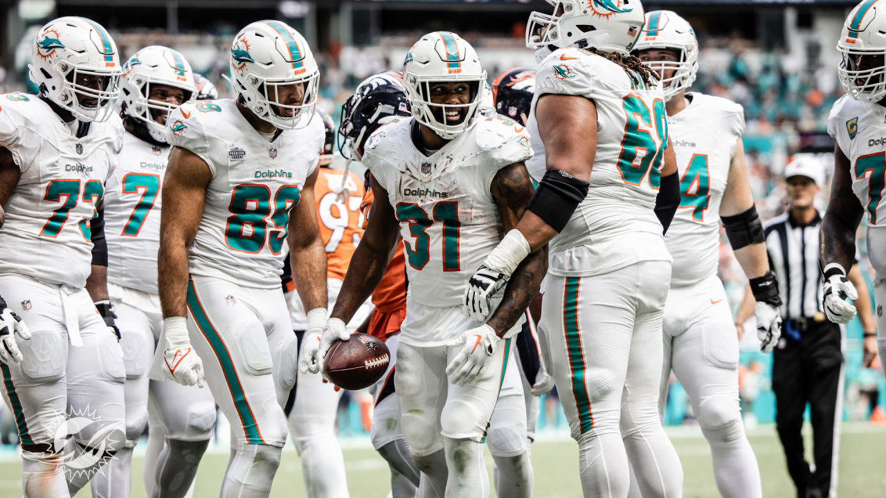 Tua Tagovailoa of the Miami Dolphins hands the ball off to Raheem