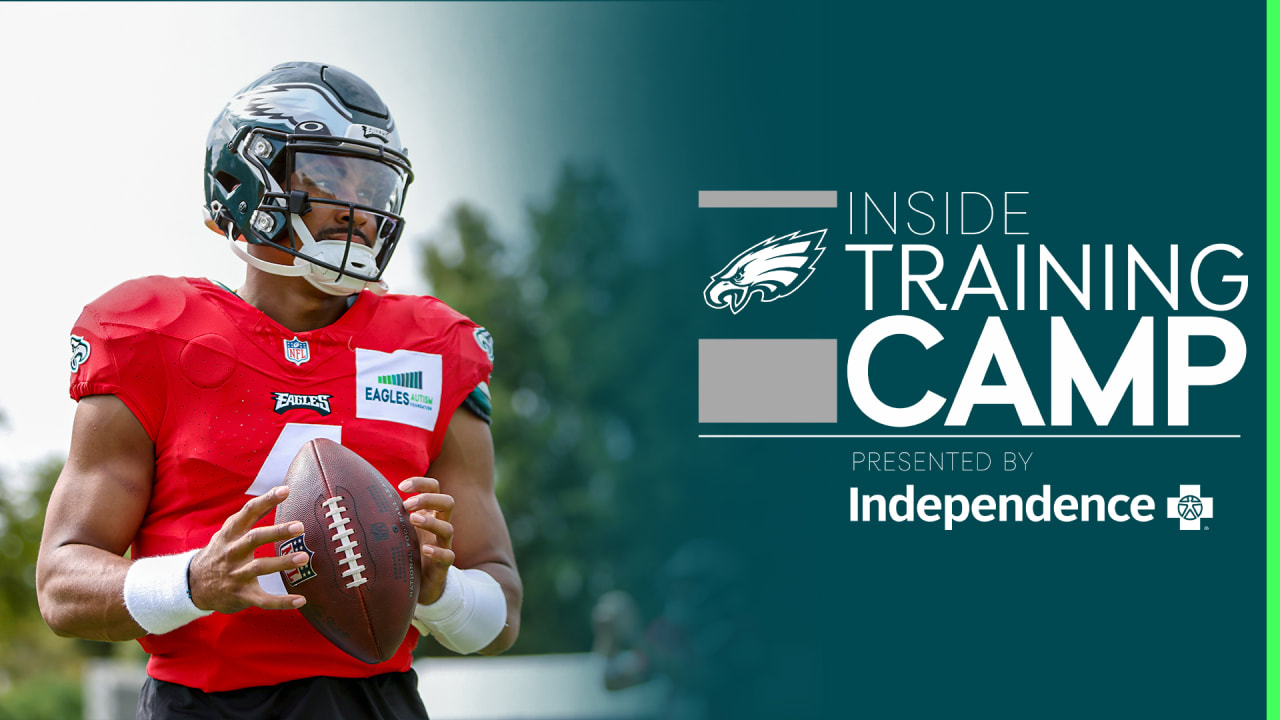 Member of the US military holds up the signed practice worm jersey of  Philadelphia Eagles quarterback Jalen Hurts for the Back Together  Saturday during practice at NFL football training camp, Saturday, July