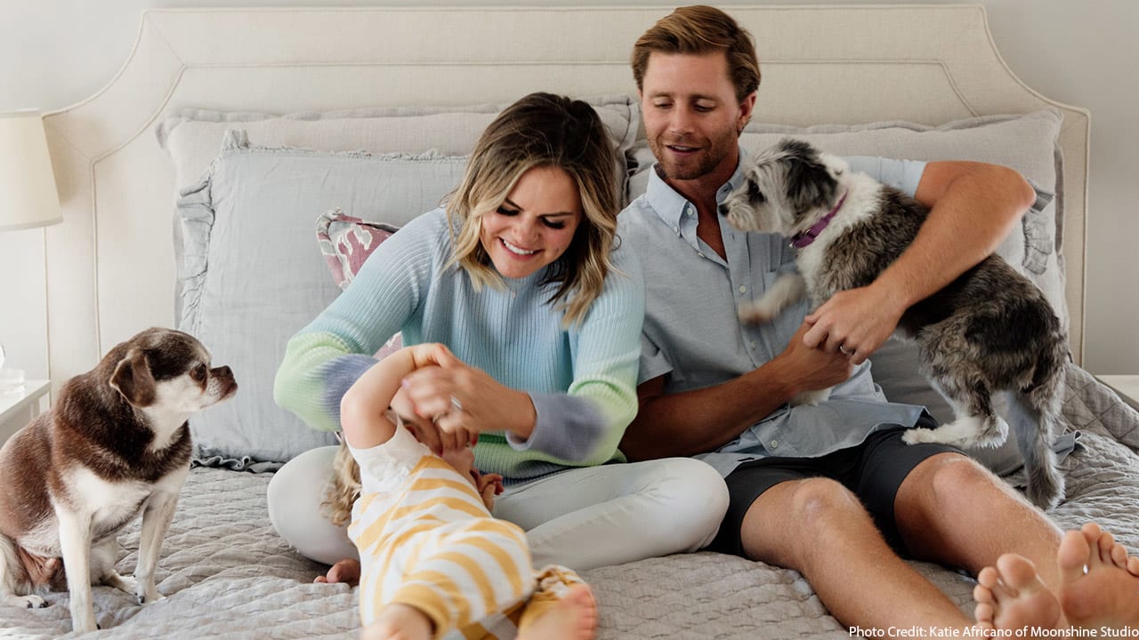 Stephen Hauschka and Lindsey Hauschka smile with their son and dogs, Jack and Bee.