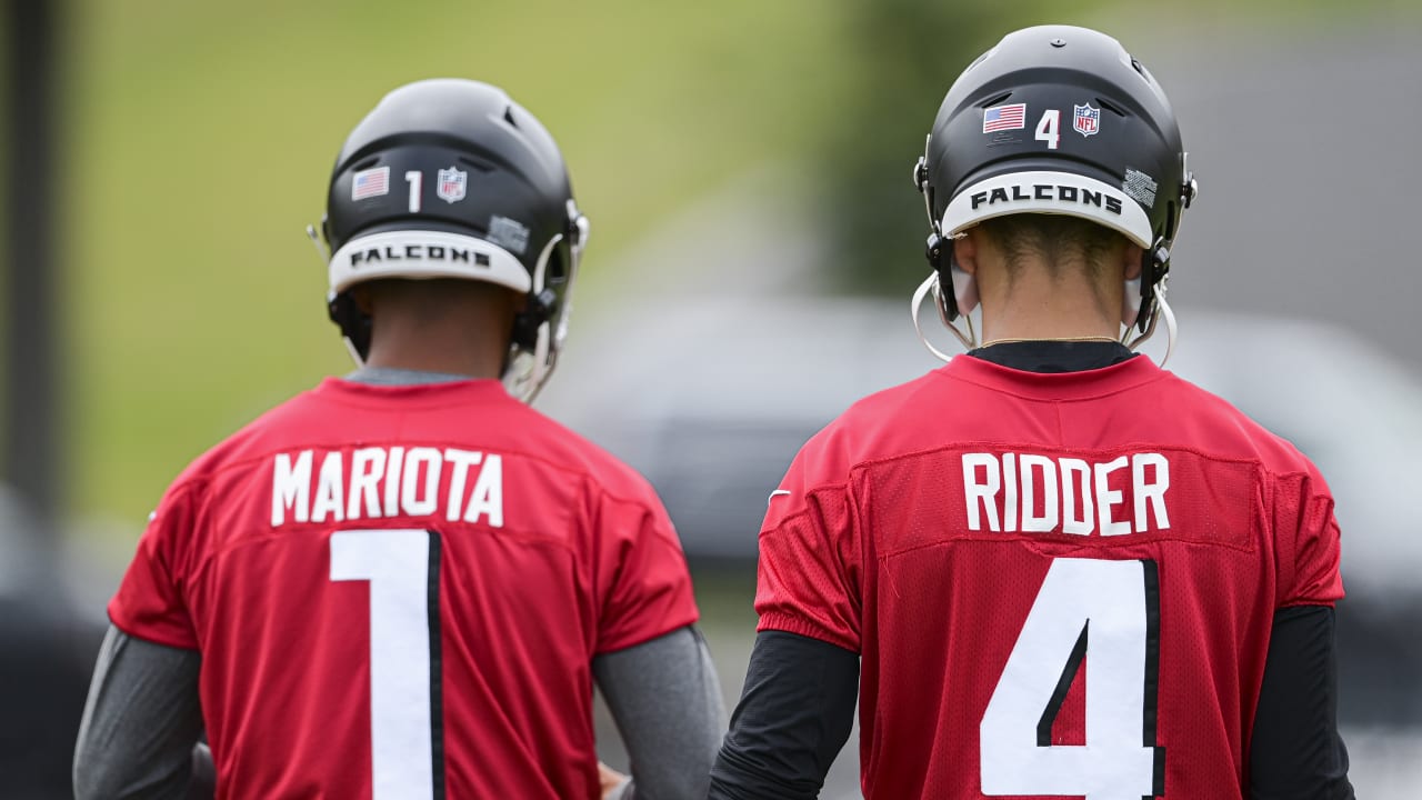 First look: Atlanta Falcons newly signed quarterback Marcus Mariota holding  his Falcons jersey, speaking with media