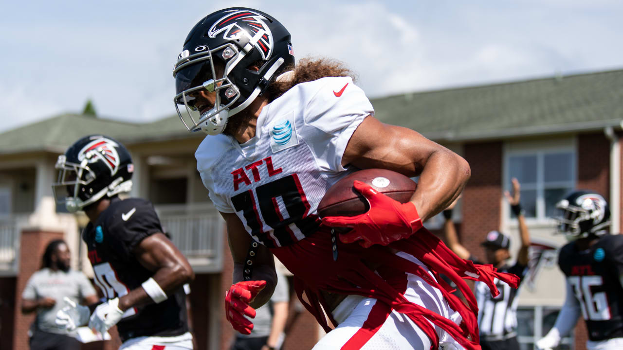 An old Atlanta Falcons helmet is raised by a fan during the first