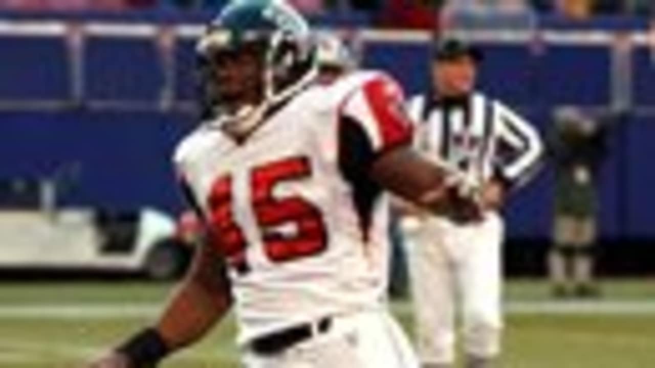 Warrick Dunn of the Atlanta Falcons runs out of the tackle of