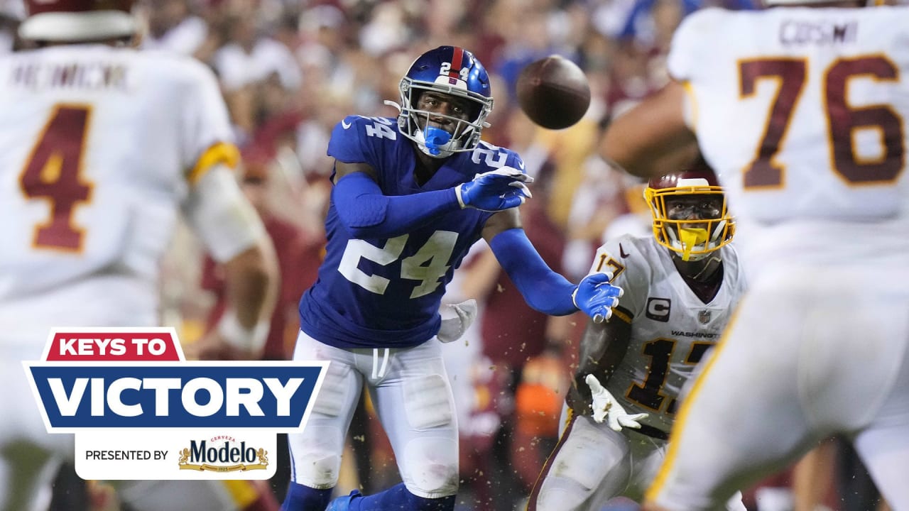 New York Giants Michael Johnson (20) holds up Washington Redskins Clinton  Portis (26) in the first quarter at Giants Stadium in East Rutherford, New  Jersey on September 4, 2008. The Giants defeated