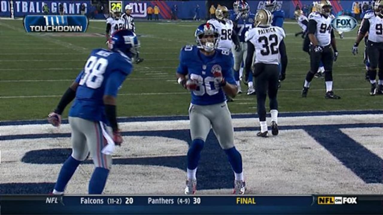 Wide receiver Victor Cruz (80) of the New York Giants kissed the  championship trophy at the conclusion of Superbowl XLVI on Sunday, February  5, 2012, at Lucas Oil Stadium in Indianapolis, Indiana.