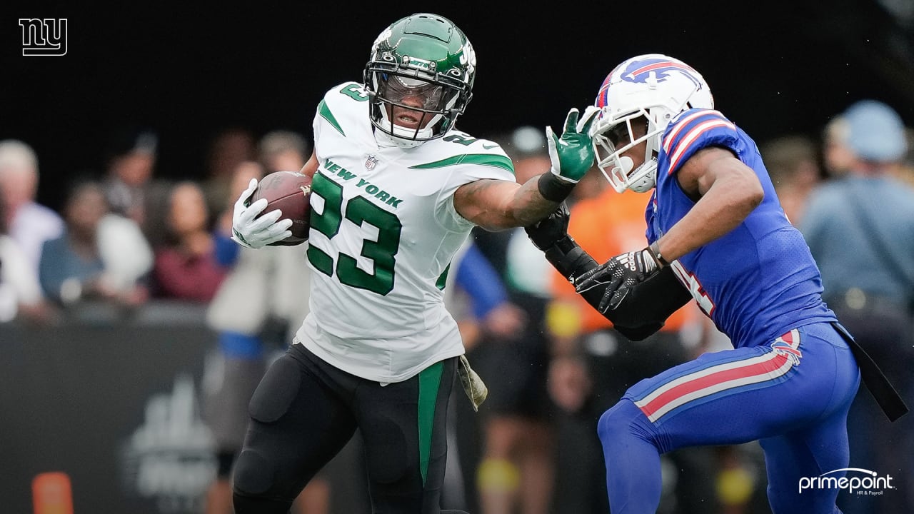 New York Jets' James Robinson (23) dives past Buffalo Bills' Tim Settle  (99) for a touchdown during the second half of an NFL football game,  Sunday, Nov. 6, 2022, in East Rutherford