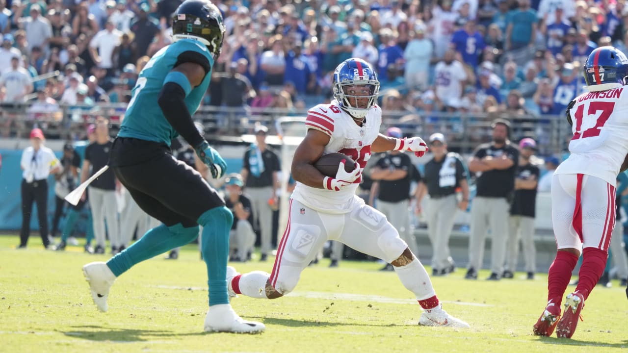 Rodney Hampton (27) of the New York Giants is tackled from behind for a  4-yard loss by Cortez Kennedy of the Seattle Seahawks during the second  quarter of NFL game at Giants