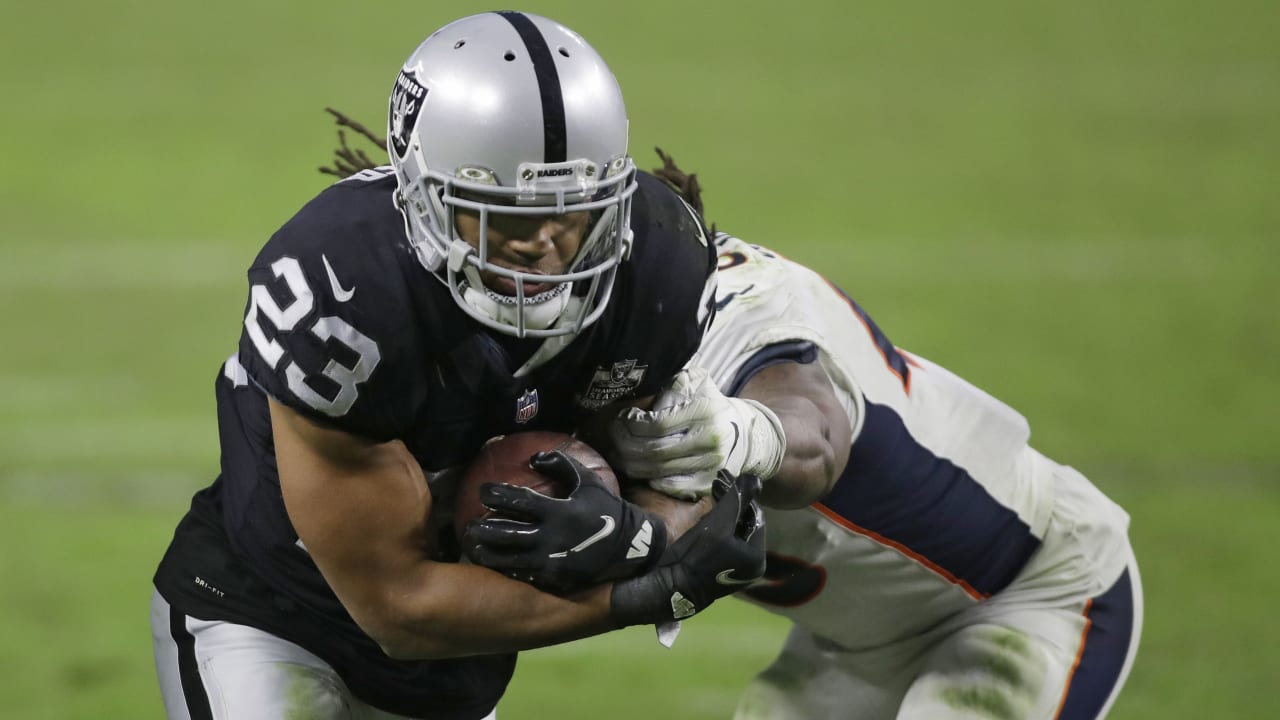 Seattle Seahawks running back Chris Carson (32) rushes against the  Cleveland Browns defensive back Jermaine Whitehead (35) during the second  half of an NFL football game, Sunday, Oct. 13, 2019, in Cleveland. (