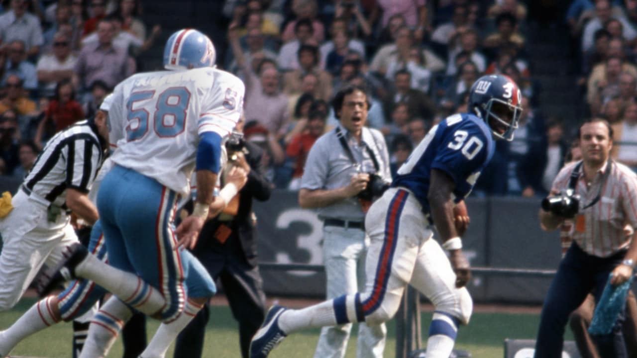 Houston Oilers quarterback Warren Moon (1) grimaces as he is