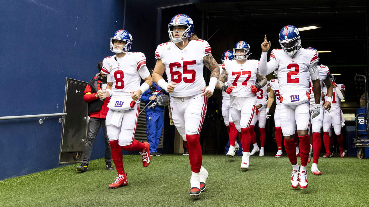 New York Giants center Nick Gates (65) lays on the field as members of the  team medical staff tend to him during the first half of an NFL football  game against the