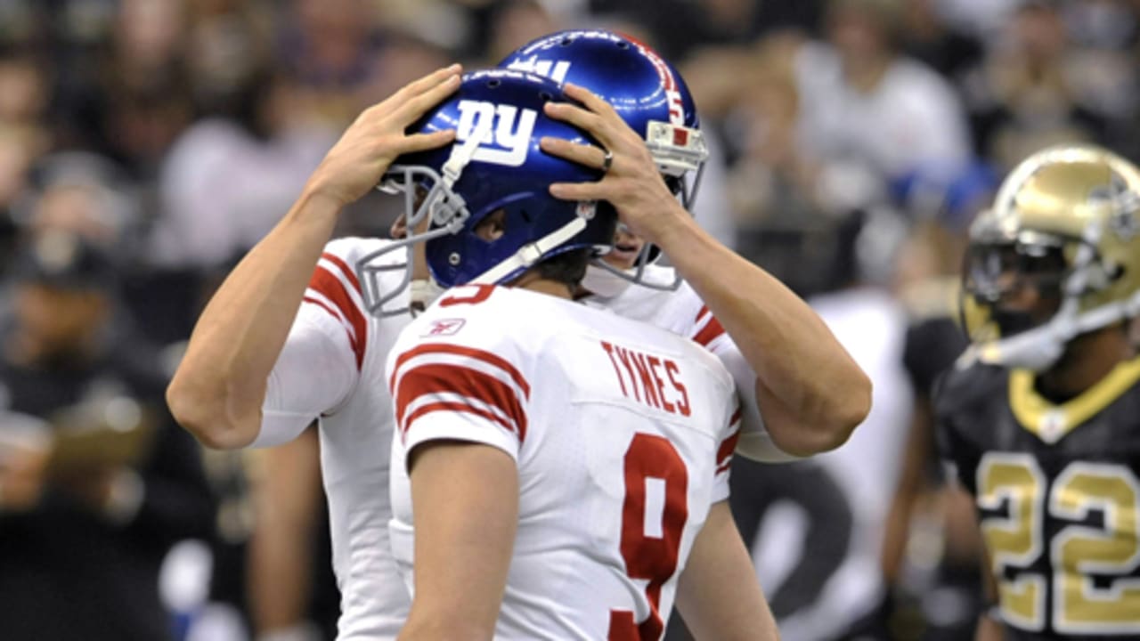 Place kicker Lawrence Tynes of the New York Giants kicks a field goal out  of the hold of punter Jeff Feagles while taking on the A…