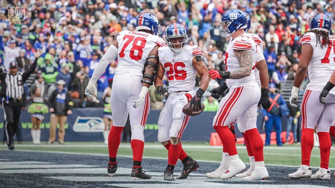 Rodney Hampton (27) of the New York Giants is tackled from behind for a  4-yard loss by Cortez Kennedy of the Seattle Seahawks during the second  quarter of NFL game at Giants