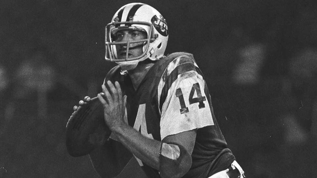 New York Jets quarter back Richard Todd holds the ball high in the