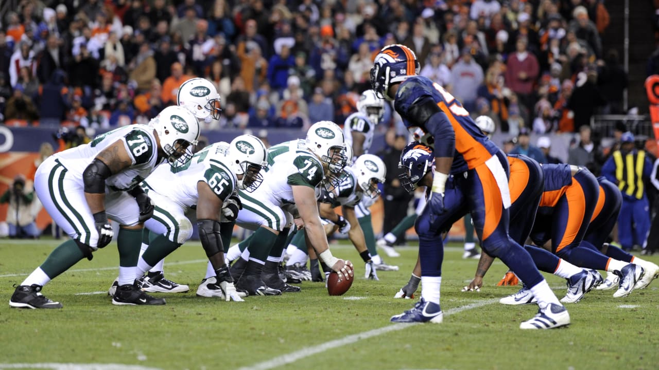 Floyd Little (44) of the Denver Broncos avoids the tackle of Jets' Steve  O'Neal (20) and continues on his way to the Jets 1-yard line where he was  tripped up in Denver