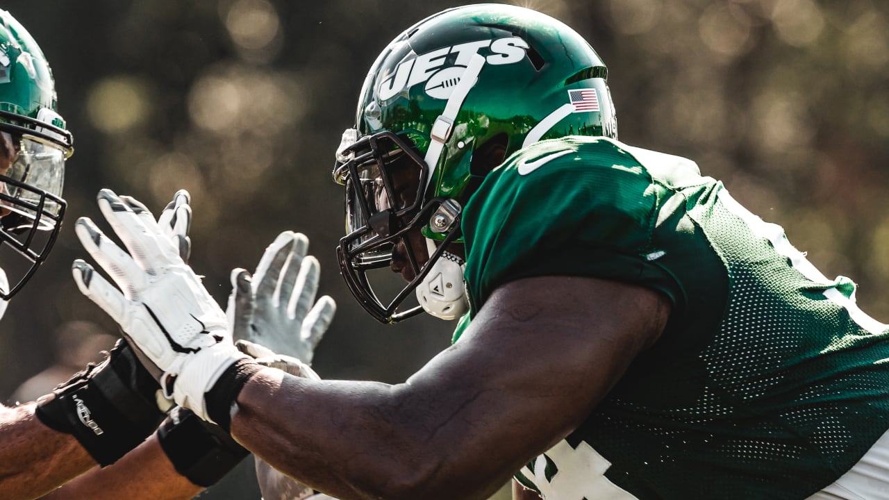 New York Jets' Folorunso Fatukasi signs a shirt for a fan at the